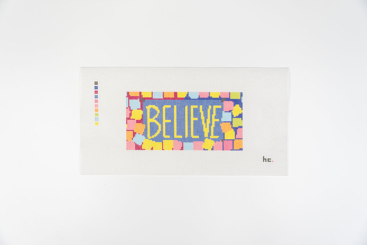 Printed needlepoint canvas reading believe in yellow letters on a periwinkle background with a border of pastel sticky notes, full view