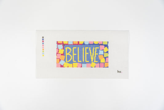 Printed needlepoint canvas reading believe in yellow letters on a periwinkle background with a border of pastel sticky notes, full view