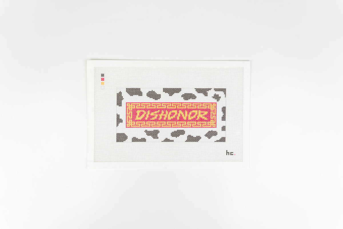 Dishonor on Your Cow printed needlepoint canvas: gold DISHONOR lettering on a red banner with a gold fretwork border, over black and white cow print, on 13 mesh canvas