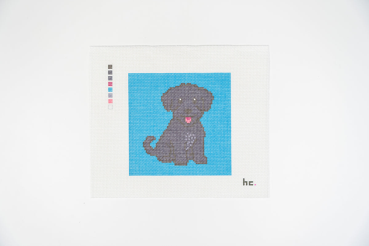 Printed needlepoint canvas of a black mini schnoodle sitting on a turquoise square background, 18 mesh, full view