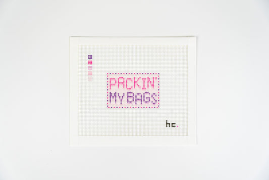 Printed needlepoint canvas reading packin my bags in hot pink and plum letters with a dotted plum border, Candy Pop colorway, on 13 mesh