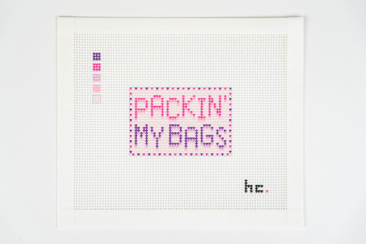 Close view of the packin my bags lettering, dotted plum border and five color thread key on 13 mesh canvas