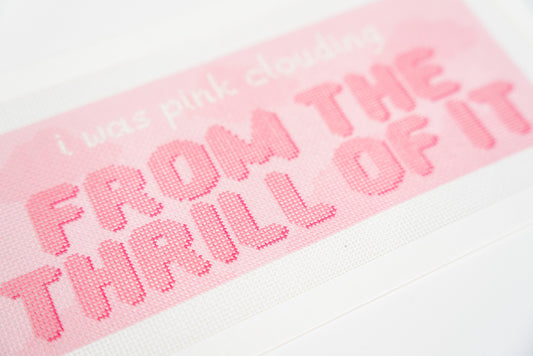Close angled view of the white script and puffy coral pink lettering on 18 mesh canvas
