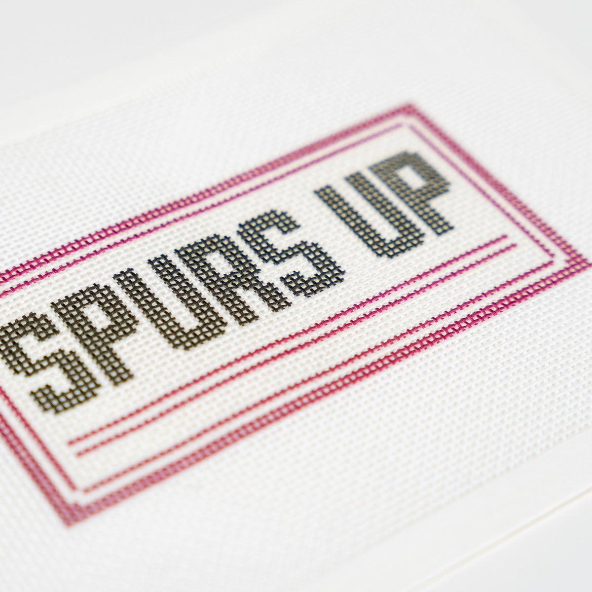 Spurs Up, stitched detail close up