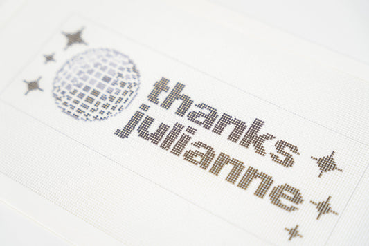 Printed needlepoint canvas reading thanks julianne, close angled view of the letters and disco ball on 18 mesh